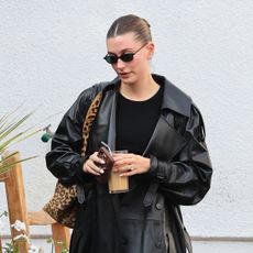 Hailey Bieber wearing a leather trench coat