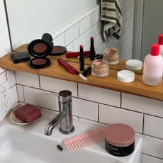 Beauty products on a bathroom shelf