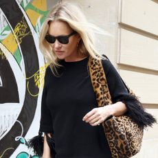 Kate Moss wears a leopard handbag