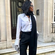 Woman in white shirt and black pants