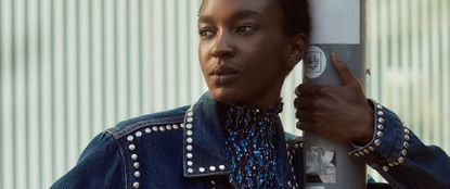 a black woman wearing denim jacket with silver bids