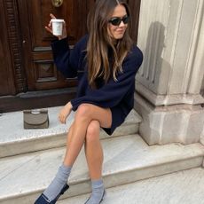 woman in navy sweater and skirt