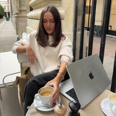 Photo of Emma Leger on her computer at a cafe