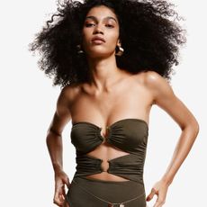 Woman wearing H&M olive green strappy one-piece swimsuit